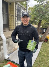 Christmas in October volunteer posing with paint